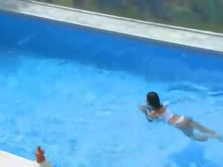Alluring busty seductress alone at the pool